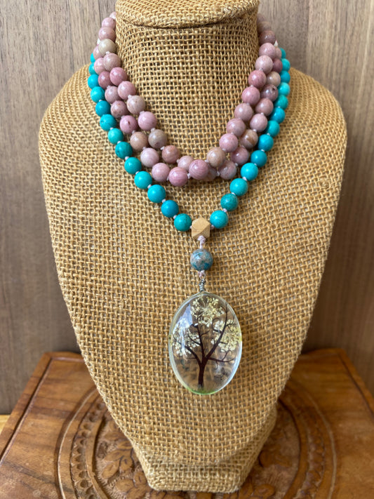 Hand-knotted 108 mala beads set featuring turquoise and rhodochrosite beads, finished with a resin Tree of Life pendant for spiritual connection