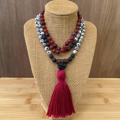 108 hand knotted mala beads featuring red agate, mookaite and dalmatian spotted beads, with lava rock and finished with a thick red tassel 